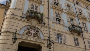 A building facade with a prominent entrance labeled "Galleria Umberto I". - La Casa del Mercato by Wonderful Italy (Turin)