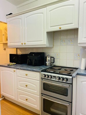 Enjoy cooking in this well-equipped kitchen with two ovens and a microwave.