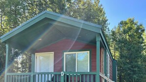 A small, single-story cabin with a green porch and a covered front porch area. - Deluxe Creekside Cabin nearby Blount's Creek! (Chocowinity)