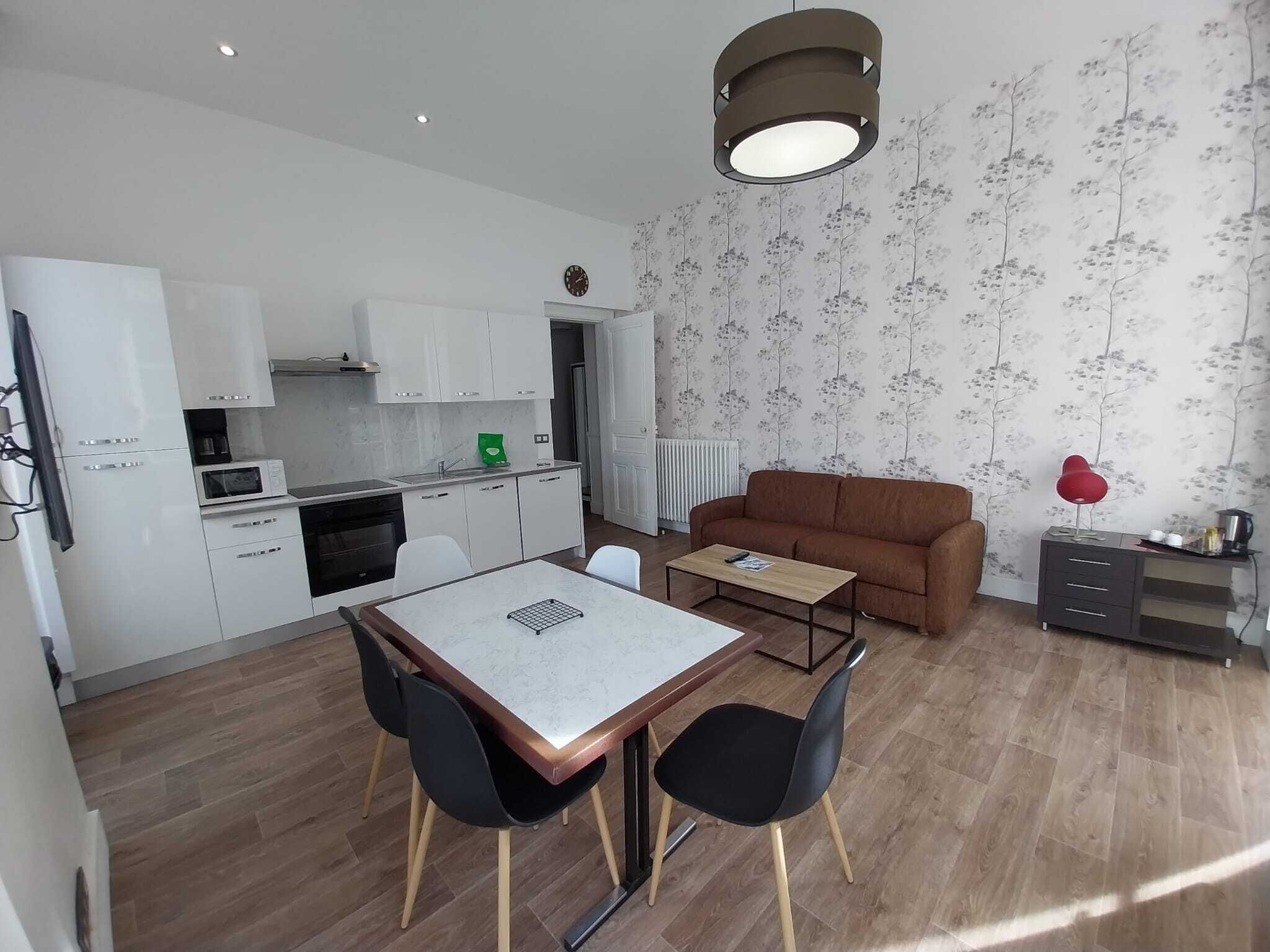 A compact living space with a kitchen, dining area, and seating.