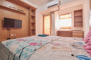 A bedroom with a bed, a TV, a wardrobe, and a window with curtains. - Room Rendi @ Gunung Putri Square by Zuzu (Gunung Putri)