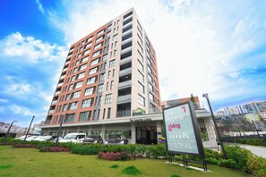 A multi-story residential building with balconies, a sign indicating it is 'The Superior Living', and a parking area with cars. - The Superior Living Kağıthane (Istanbul)