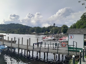 A pier with wooden walkways, boats docked, and a sign indicating 'Pier 2'. - Ye Old'e Man - Sleeps 6 & Pet Friendly (Grange-over-Sands)