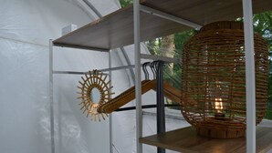 A modern interior with white walls, a wooden shelf, and a wicker lamp. - Bubble Tent Loiret: nature and comfort, close to the Loire castles (Chuelles)
