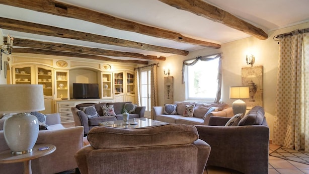 Un salon chaleureux avec une cheminée, des fauteuils confortables et un téléviseur.
