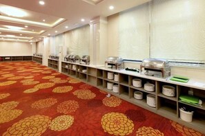 A conference room with a patterned carpet, buffet setup, and a long table. - Naerdasi Hotel (Nanjing)