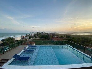 Outdoor pool, open 8:00 AM to 8:00 PM, pool umbrellas, pool loungers