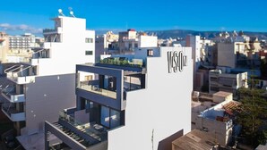 A modern building with balconies and a rooftop garden, labeled 'VISON.' - Vision Lavraga (Athens)