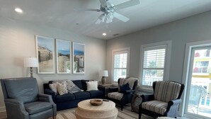 A spacious living room with a ceiling fan, a large round coffee table, and a variety of seating options including a sofa and armchairs. - Beach block/Ocean View 82nd Street (Ocean City)