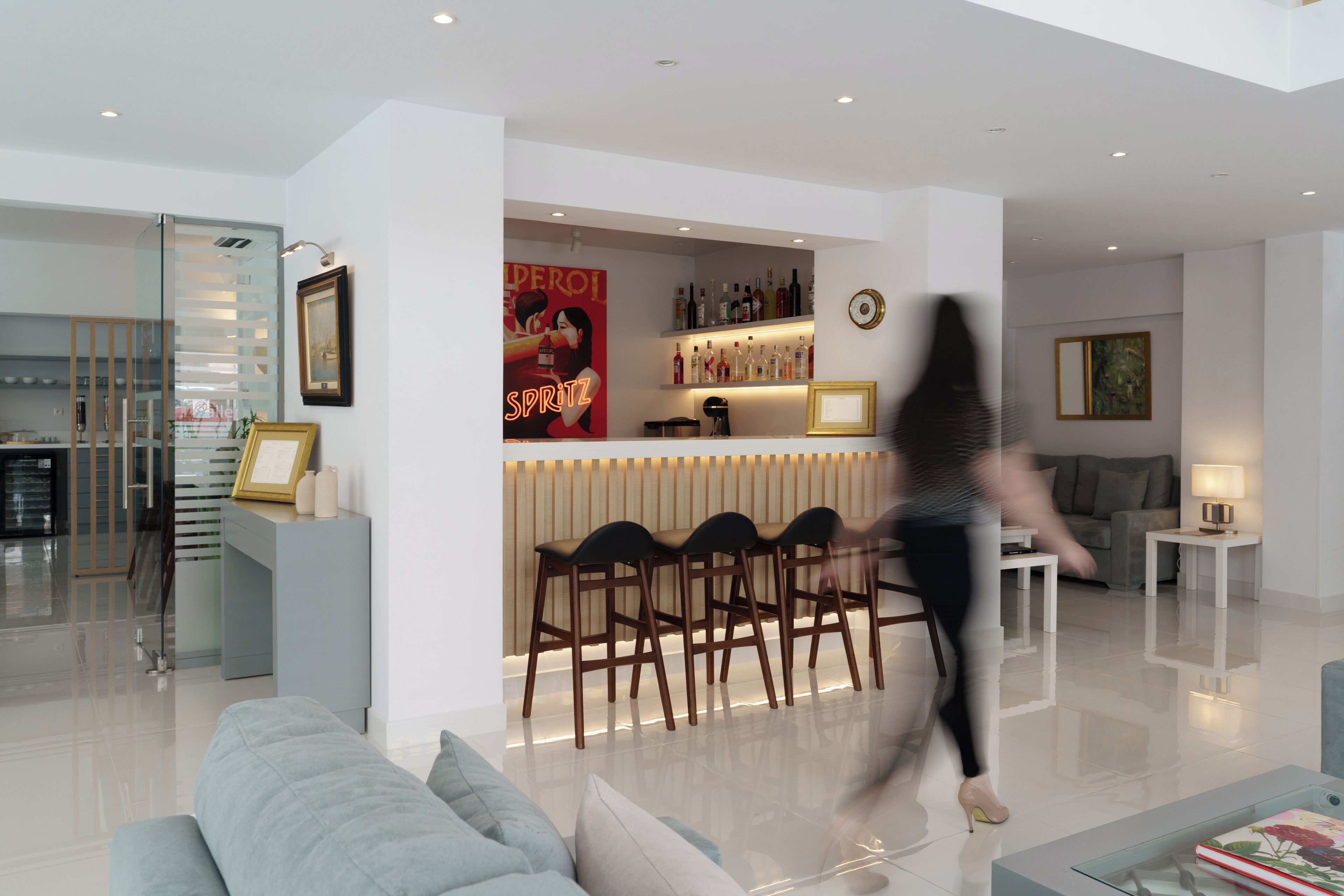 A modern living room with a bar area, a sofa, and a coffee table.
