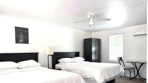 A hotel room with two beds, a ceiling fan, a desk with a chair, and a wardrobe. - Room 6 at Inland Lakes Motel, Indian River, MI (Indian River)