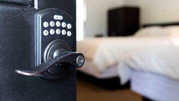 A hotel room door with a keypad lock and a keyhole.