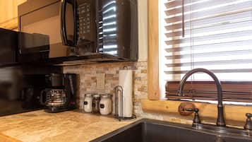 Fridge, microwave, coffee/tea maker, cookware/dishes/utensils