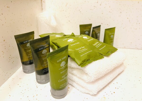 A bathroom with various toiletries including bottles and bars of soap.