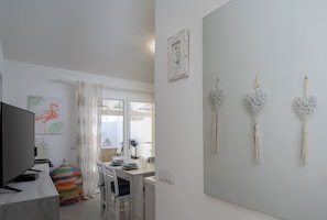 Apartment, Garden View | Living area | 35-inch TV with digital channels