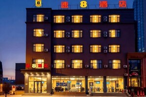 A multi-story hotel with a prominent entrance and signage.