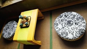 A wall-mounted control panel with two patterned plates below it. - Dongtai Dashijie Hotel (Kuandian)