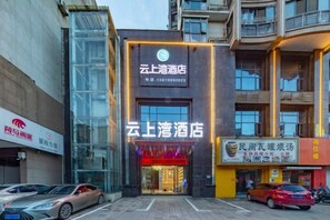 A hotel with a modern facade, large windows, and a prominent entrance. - Core Clould of hotel (Nanchang County)