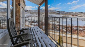 A balcony with a view of a snowy landscape and a clear sky. - Ski-In/Ski-Out Mountain Retreat with Pool and Private Indoor Hot Tub (Granby)