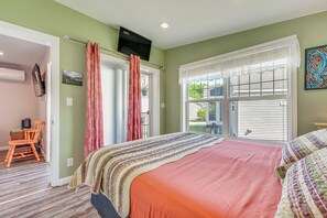 A bedroom with a large bed, a television mounted on the wall, and a window with blinds. - 2 Mi to Moody Beach, Amenity Access: Wells Getaway (Wells)