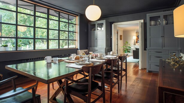 A dining area with a large table, chairs, and a view through the window. - Spacious Converted Carriage House in Historic District near USNA (Annapolis)