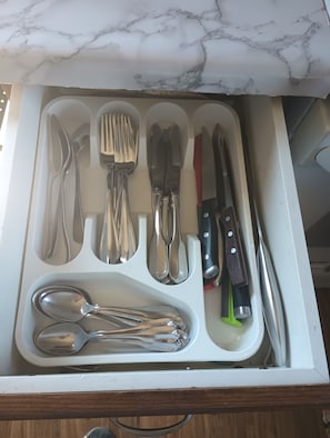 A drawer with various kitchen utensils including forks, knives, and spoons. - Relax on Benson Lake, Rideau System (Westport)