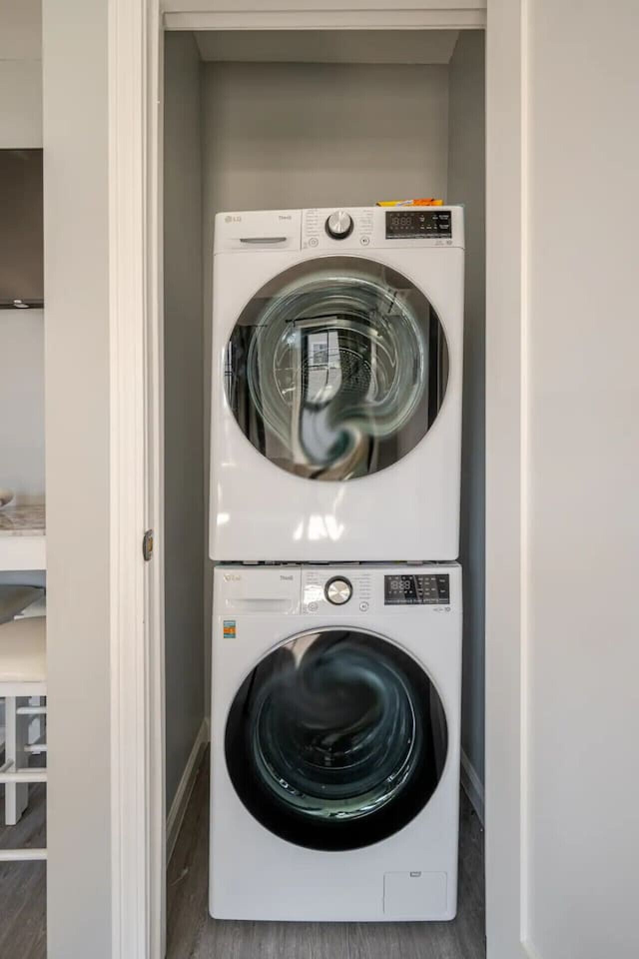A laundry room with two stacked front-loading washing machines.