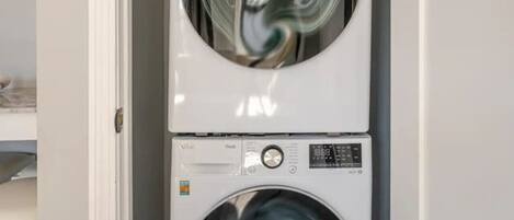 A laundry room with two stacked front-loading washing machines.