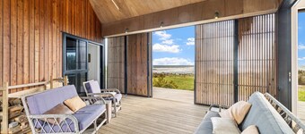 Sauna, seafront, and architecture steps away from the Tasman Sea