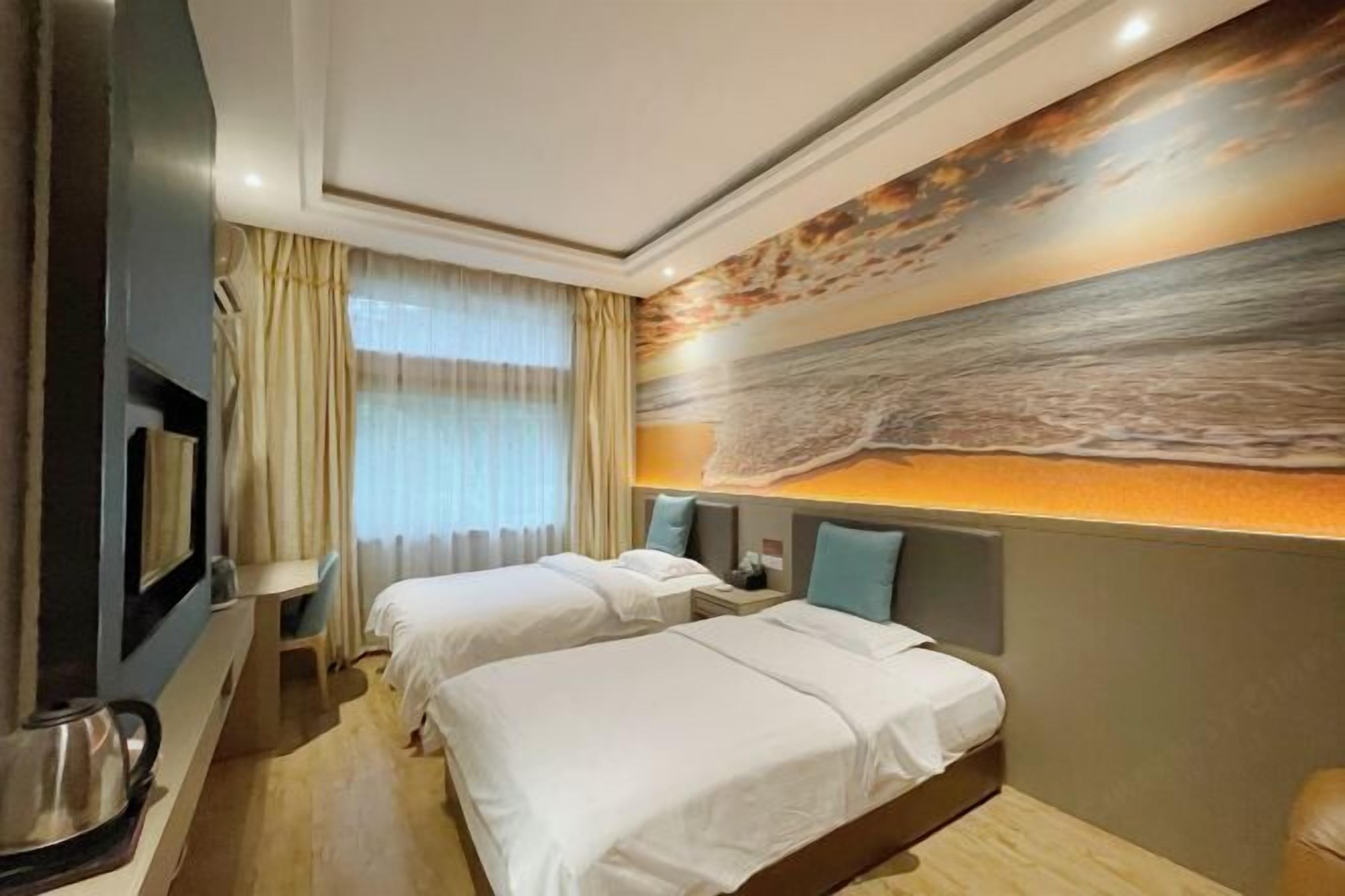 A hotel room with two beds, a large painting on the wall, and a window with curtains.