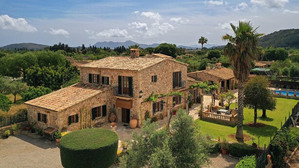 A stone villa with multiple balconies, a swimming pool, and lush greenery. - TONI MOSCA. Superb villa close to Pollensa (Pollensa)