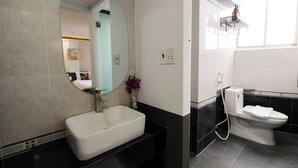 A bathroom with a white sink, a toilet, a mirror, and a shower. - Ruby Star Hotel Nam Quoc Cang (Ho Chi Minh City)