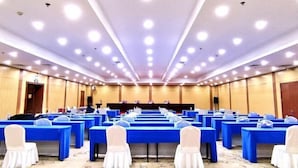 A conference room with rows of tables and chairs, equipped with microphones and water bottles. - Harbin Kunlun Hotel (Near Central Street & Harbin Railway Station) (Harbin)