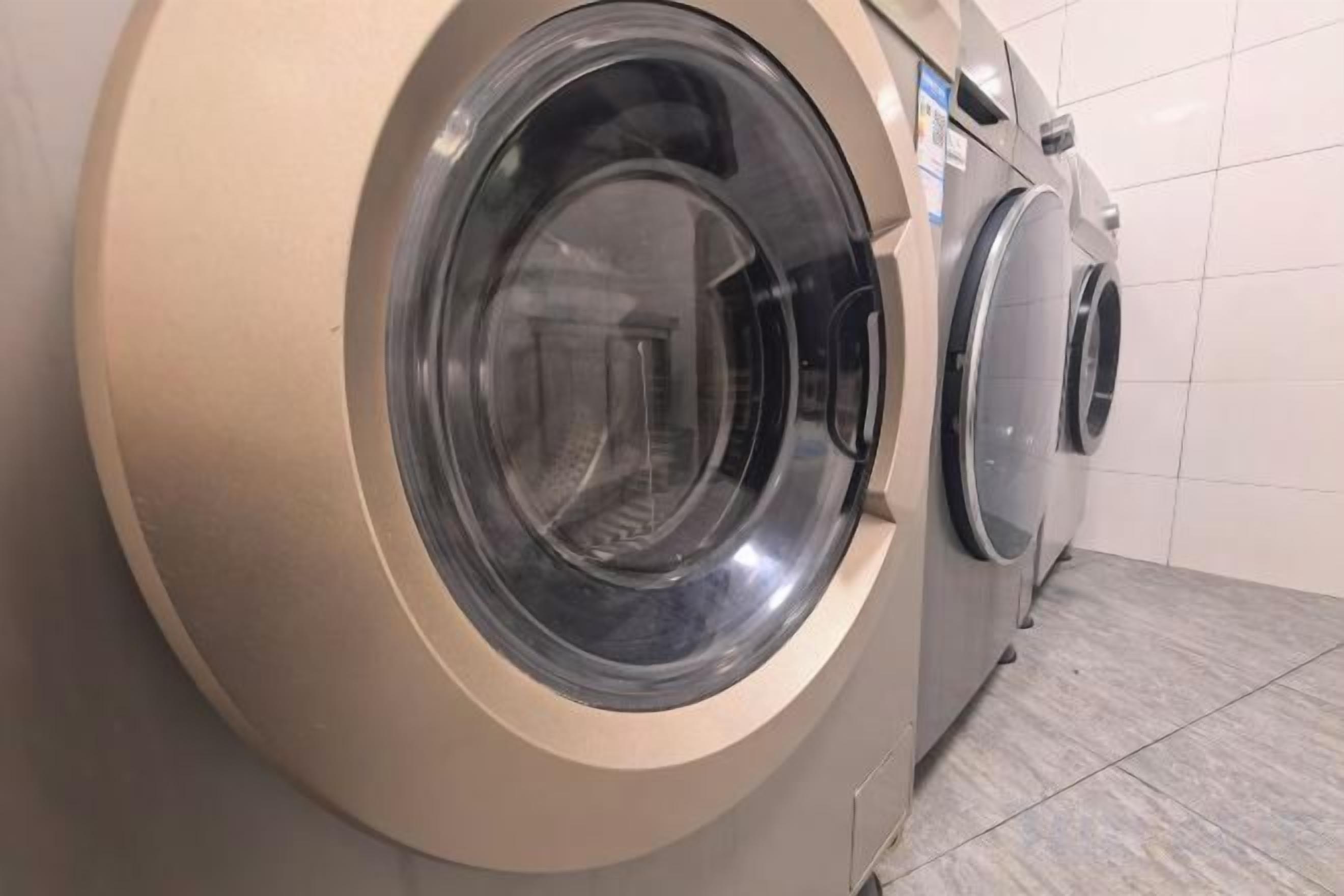 A front view of a washing machine in a commercial setting.