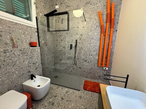 Bathroom features a walk-in shower, pedestal sink, and bathtub.