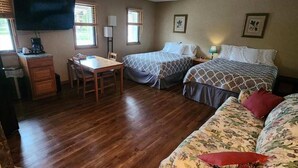 A room with two beds, a desk, a chair, and a television. - Schuss Village Studio Unit 117 True Ski-in/Ski-out. (Bellaire)