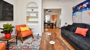 A living room with a wooden coffee table, a sofa, a chair, and a bookshelf. - "Good Vibes" 4 Wonderful Seasons @ Portland Home! (Portland)