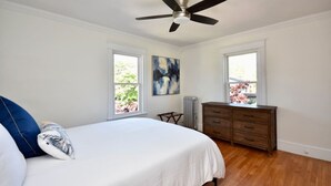 A bedroom with a bed, a dresser, a radiator, and a ceiling fan. - "Good Vibes" 4 Wonderful Seasons @ Portland Home! (Portland)