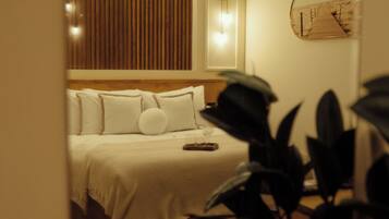 Una habitación de hotel con cama, mesita de noche y un reloj en la pared.