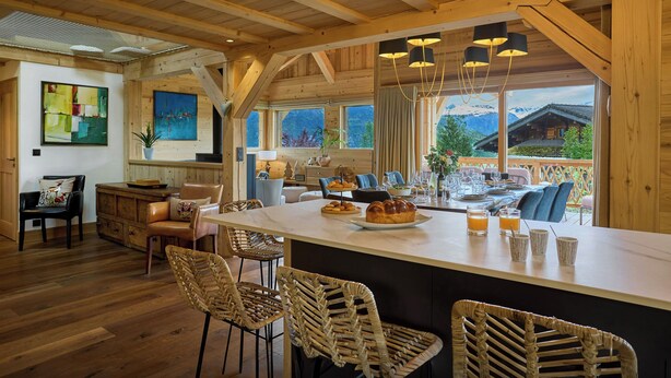 A spacious kitchen with a large island, wooden beams, and a view of mountains. - Chalet Anselme - luxury stay for 10 with Mont Blanc views - OVO Network (Cordon)