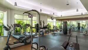 A spacious gym with treadmills, elliptical machines, and weight equipment. - Casa Bonita, Oceanfront, Private pool condo, Mareazul (Playa del Carmen)