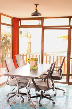 A conference room with a table, chairs, and a ceiling light. - Lidia Anturios Suites (Oaxaca)