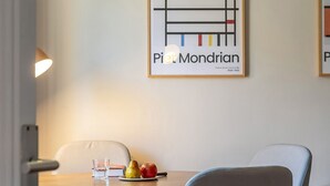 A dining area with a table, chairs, a lamp, and a framed artwork on the wall. - Beautiful apartment near Plaza Catalunya (Barcelona)