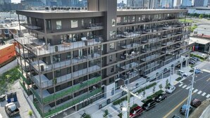 A multi-story building with a modern architectural design, featuring balconies and large windows. - Tequila Sunrise Downtown Condo, Walk to Broadway! (Nashville)