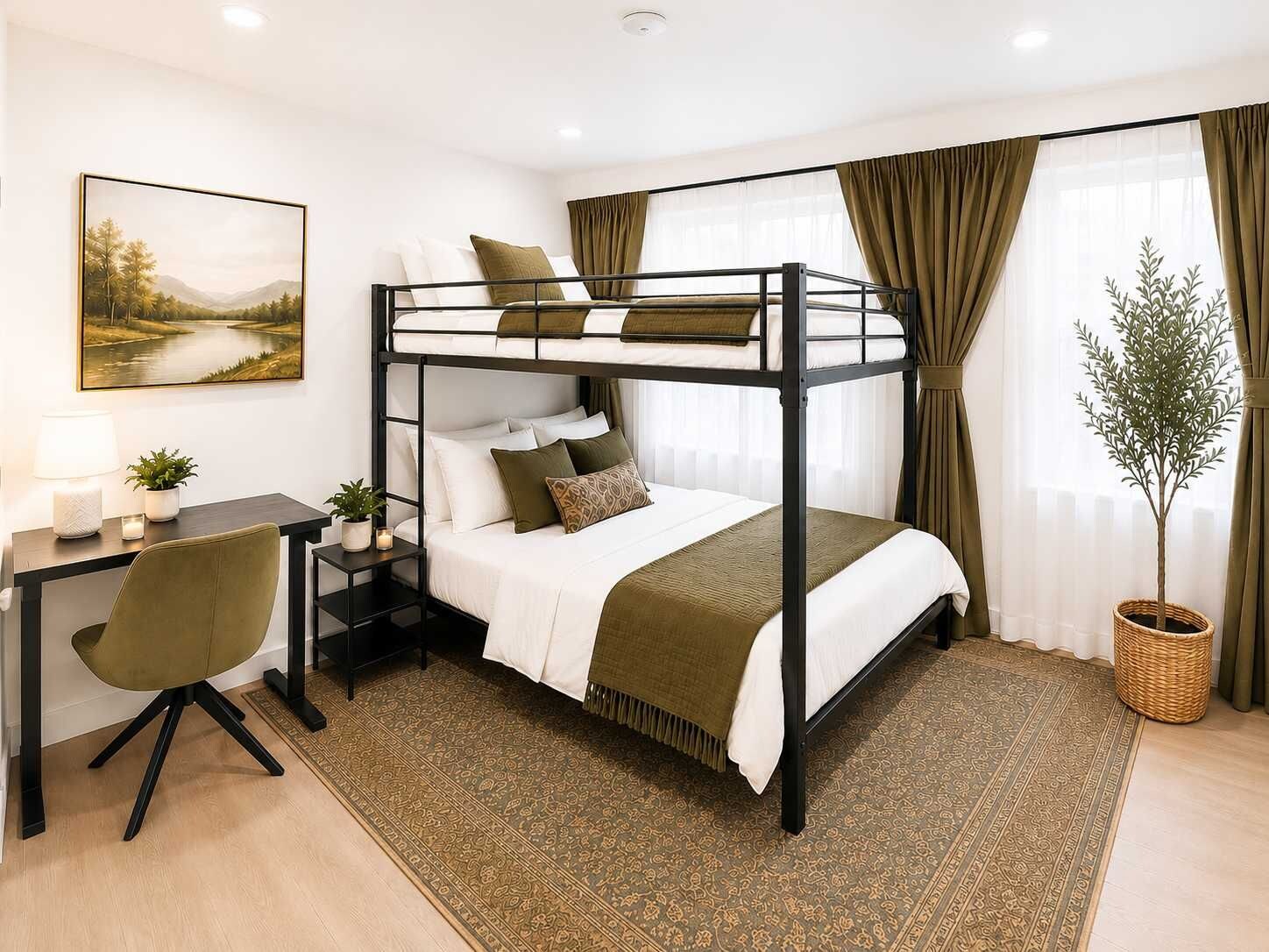 A bunk bed with a desk and chair, a potted plant, and a painting on the wall.