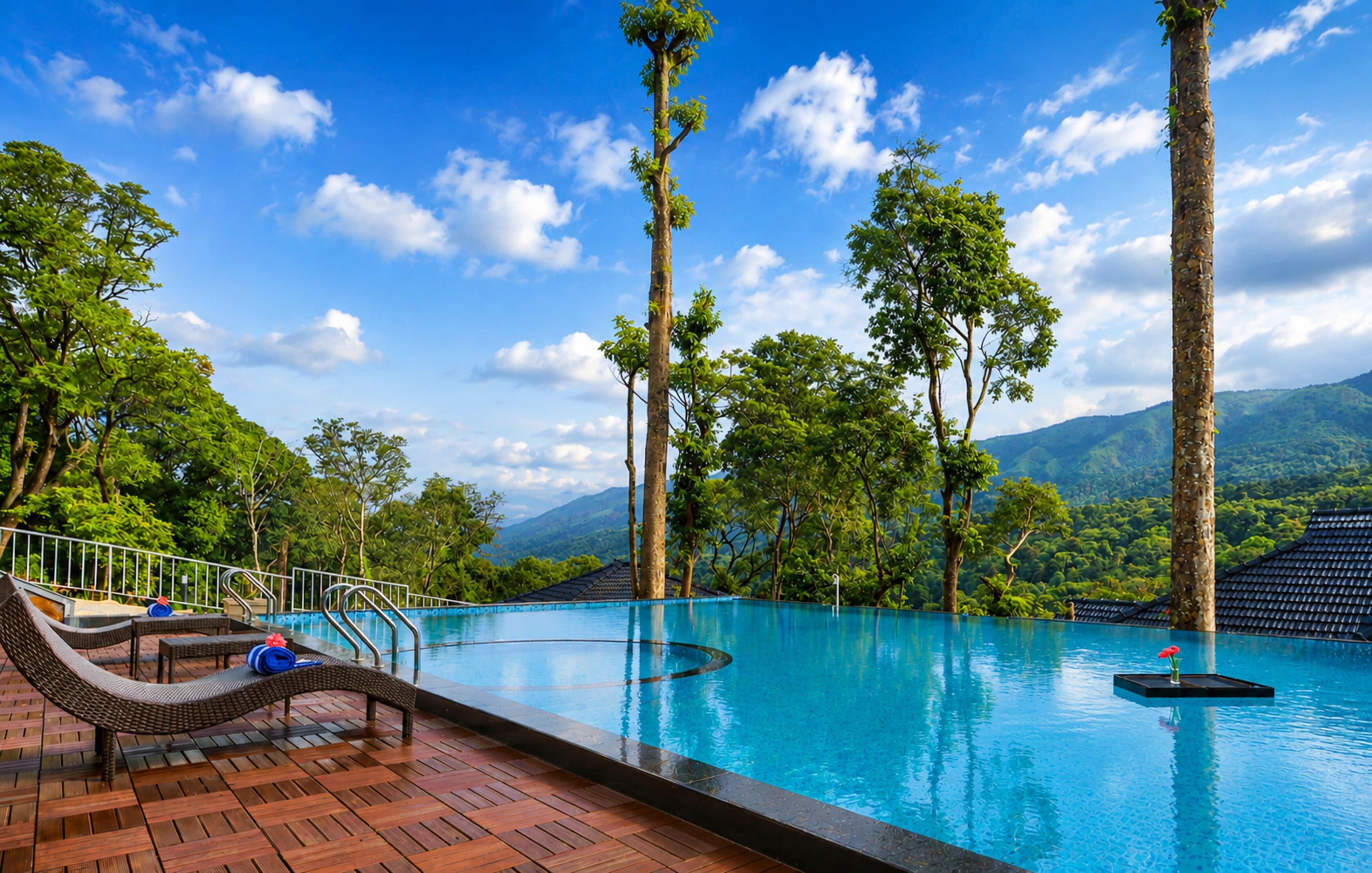 A pool area with lounge chairs and a view of a mountainous landscape.