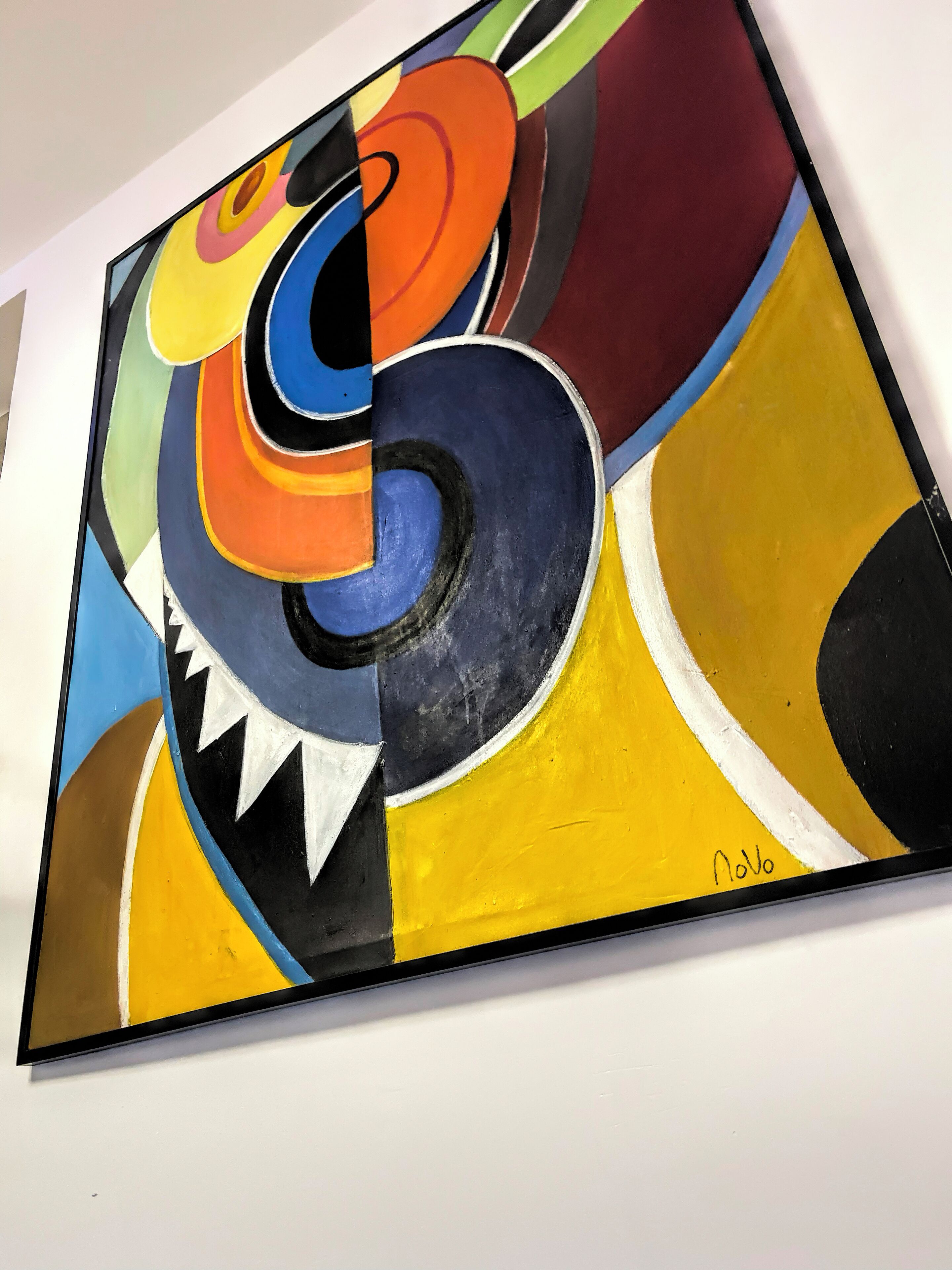 A colorful abstract painting with bold shapes and vibrant colors.