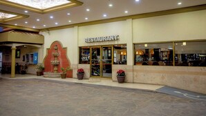A restaurant with a tiled entrance, potted plants, and a sign above the door. - Hotel San Martin (Hermosillo)
