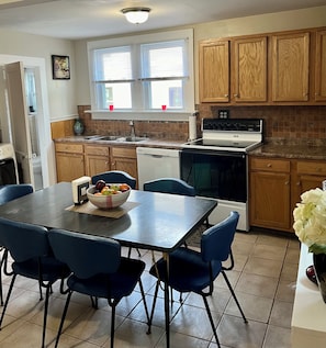 Enjoy cooking in this well-equipped kitchen with a central island, sink, stove, and dishwasher.