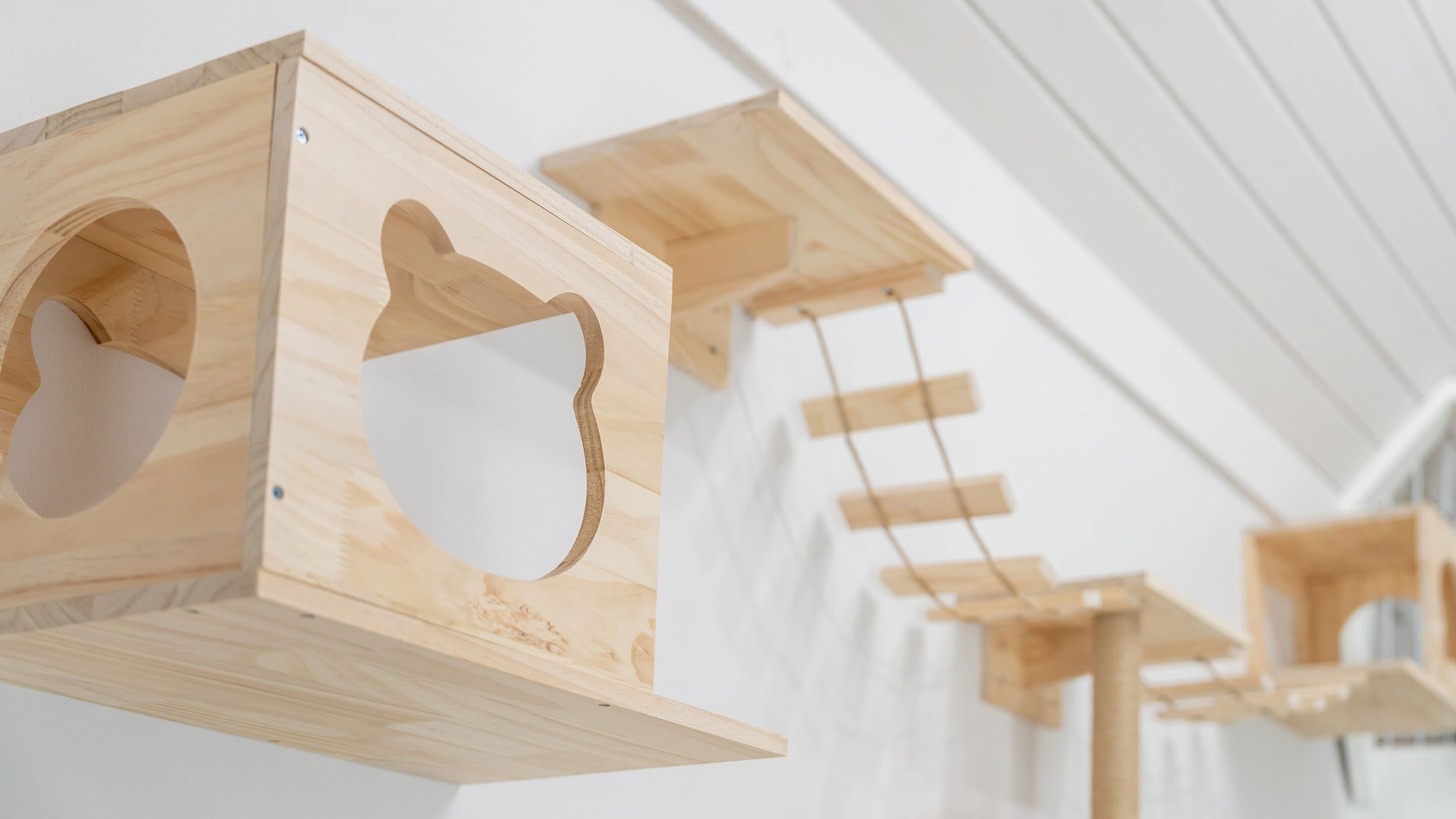 Wooden hanging structures with cut-out shapes, likely for decorative purposes.